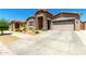 Attractive single-story home with stone accents, desert landscaping, and neutral exterior at 24013 N 165Th Ave, Surprise, AZ 85387