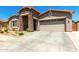 Inviting single-story home features a stone entrance, neutral stucco, and a two-car garage at 24013 N 165Th Ave, Surprise, AZ 85387