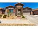 Beautiful single-story home with desert landscaping and stone accents on the entryway at 24013 N 165Th Ave, Surprise, AZ 85387
