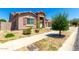Single-story home with desert landscaping, stone accents, and a two-car garage at 24013 N 165Th Ave, Surprise, AZ 85387