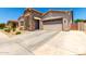 Well-kept single-story home with a stone entryway and a spacious two-car garage at 24013 N 165Th Ave, Surprise, AZ 85387