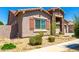 Charming home with desert landscaping, a stone accented entrance, and neutral exterior at 24013 N 165Th Ave, Surprise, AZ 85387