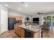Open kitchen featuring wood cabinets, granite counters and a modern black refrigerator at 24013 N 165Th Ave, Surprise, AZ 85387