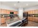 Spacious kitchen featuring a center island with seating and modern black appliances at 24013 N 165Th Ave, Surprise, AZ 85387