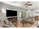 Cozy living room featuring wood floors, a fireplace, and access to the patio through sliding doors at 24013 N 165Th Ave, Surprise, AZ 85387