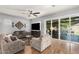 Comfortable living room with neutral tones, wood floors, and sliding glass doors to the patio at 24013 N 165Th Ave, Surprise, AZ 85387