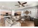 Open-concept living area flowing into a kitchen with wood floors and neutral décor at 24013 N 165Th Ave, Surprise, AZ 85387