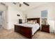 Bright main bedroom featuring a dark wood bedroom set, neutral decor, and ceiling fan at 24013 N 165Th Ave, Surprise, AZ 85387