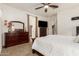 Bright main bedroom featuring a dark wood bedroom set with a dresser and mirror at 24013 N 165Th Ave, Surprise, AZ 85387