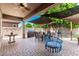 Covered patio with brick pavers, outdoor dining furniture, and backyard views at 24013 N 165Th Ave, Surprise, AZ 85387