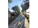 Well-maintained sidewalk lined with mature trees and flowering bushes, providing a pleasant walking experience at 24013 N 165Th Ave, Surprise, AZ 85387