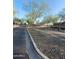 Cobblestone street lined with trees and well-maintained landscaping, leading to attractive homes in a quiet neighborhood at 24013 N 165Th Ave, Surprise, AZ 85387