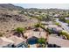 Aerial shot of a neutral-toned desert home featuring mature landscaping, nestled in a scenic, quiet neighborhood at 2422 E Rockledge Rd, Phoenix, AZ 85048