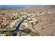 Panoramic aerial view of desert homes nestled amongst mountains, featuring neutral tones and professionally landscaped yards at 2422 E Rockledge Rd, Phoenix, AZ 85048