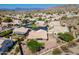 Scenic aerial view of neutral colored desert homes with mountain views, nestled within a vibrant, landscaped community at 2422 E Rockledge Rd, Phoenix, AZ 85048