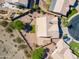 Aerial view of a single-story home with a neutral paint scheme, tile roof, and mature landscaping in a desert community at 2422 E Rockledge Rd, Phoenix, AZ 85048