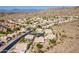 Expansive aerial view of a desert residential community nestled amongst mountains, with neutral-toned homes and mature landscaping at 2422 E Rockledge Rd, Phoenix, AZ 85048