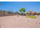 A well maintained backyard with gravel, a patch of artificial grass, desert landscaping, and privacy fence at 2422 E Rockledge Rd, Phoenix, AZ 85048
