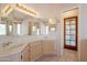 Bright bathroom featuring a double sink vanity with ample counter space and a doorway leading to outdoor light at 2422 E Rockledge Rd, Phoenix, AZ 85048