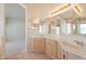 Bright bathroom featuring a double sink vanity with ample counter space and storage cabinets at 2422 E Rockledge Rd, Phoenix, AZ 85048