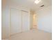 Bright bedroom with neutral walls and carpet features closet with sliding doors at 2422 E Rockledge Rd, Phoenix, AZ 85048