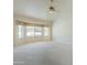 Bright primary bedroom with ceiling fan and bay window at 2422 E Rockledge Rd, Phoenix, AZ 85048