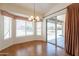 Dining area with wood floors, bay window, and sliding glass door leading to backyard patio at 2422 E Rockledge Rd, Phoenix, AZ 85048
