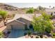 Aerial view of a single-story home with a neutral paint scheme, tile roof, mature landscaping, and a two-car garage at 2422 E Rockledge Rd, Phoenix, AZ 85048
