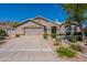 Inviting single-story home with a desert landscape, spacious driveway, and attached two-car garage at 2422 E Rockledge Rd, Phoenix, AZ 85048