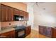 Gourmet kitchen featuring granite countertops, cherry cabinets, tile flooring, and stainless steel appliances at 2422 E Rockledge Rd, Phoenix, AZ 85048
