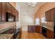 Gourmet kitchen featuring granite countertops, cherry cabinets, tile flooring, and stainless steel appliances at 2422 E Rockledge Rd, Phoenix, AZ 85048