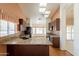 Spacious kitchen with granite countertops, skylights, cherry cabinets and a breakfast bar at 2422 E Rockledge Rd, Phoenix, AZ 85048