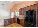 Well-lit kitchen with granite countertops, cherry cabinets, stainless steel appliances, and hardwood floors at 2422 E Rockledge Rd, Phoenix, AZ 85048