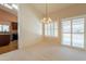 Living room showcases white carpet, shutters, and a view to the kitchen at 2422 E Rockledge Rd, Phoenix, AZ 85048