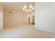 Spacious living room with neutral carpet and traditional chandelier at 2422 E Rockledge Rd, Phoenix, AZ 85048