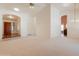 Open living area with a ceiling fan, neutral carpet, and views to other rooms at 2422 E Rockledge Rd, Phoenix, AZ 85048