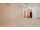 Spacious living area with neutral carpet, a ceiling fan, and doorways leading to other rooms at 2422 E Rockledge Rd, Phoenix, AZ 85048