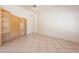 Open-concept living room with custom built-in cabinets and tile flooring throughout main living space at 2422 E Rockledge Rd, Phoenix, AZ 85048