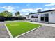 Large backyard featuring a well-maintained lawn game, sitting area and a gravel area perfect for recreation at 2509 E Meadowbrook Ave, Phoenix, AZ 85016