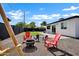 Spacious backyard featuring a swing set, red Adirondack chairs, fire pit, and a well-maintained putting green at 2509 E Meadowbrook Ave, Phoenix, AZ 85016