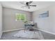 Bright bedroom with a ceiling fan, gray walls, carpet and a window offering ample natural light at 2509 E Meadowbrook Ave, Phoenix, AZ 85016