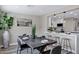 Dining area with open layout to kitchen, featuring dark wood table and seating for six at 2509 E Meadowbrook Ave, Phoenix, AZ 85016