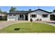 Charming single-Gathering home featuring a well-manicured lawn, brick driveway and shutters at 2509 E Meadowbrook Ave, Phoenix, AZ 85016