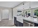 Contemporary kitchen with marble countertops, dark cabinetry, and a farmhouse sink at 2509 E Meadowbrook Ave, Phoenix, AZ 85016