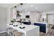 Modern kitchen featuring white and navy cabinets, stainless steel appliances, and a marble island with seating at 2509 E Meadowbrook Ave, Phoenix, AZ 85016