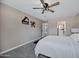 Spacious main bedroom featuring a ceiling fan, patterned carpet flooring, and ensuite bathroom entrance at 2509 E Meadowbrook Ave, Phoenix, AZ 85016