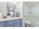 Bathroom featuring blue vanity with solid surface countertop and framed mirror above at 2625 E Indian School Rd # 343, Phoenix, AZ 85016