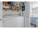 Convenient laundry room area with washer, dryer and added storage shelves at 2625 E Indian School Rd # 343, Phoenix, AZ 85016
