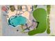 Aerial view of the backyard with a large pool, artificial grass, a patio, and desert landscaping at 2699 E Claxton Rd, Gilbert, AZ 85297