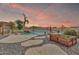 Beautiful backyard with a custom pool, lush landscaping, a pergola, and a raised garden bed at 2699 E Claxton Rd, Gilbert, AZ 85297